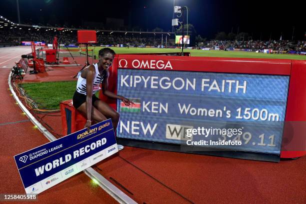 Faith Kipygeon of Kenya celebrates next to the display with the result at the end of the women's 1500m during the Wanda Diamond League Golden Gala...