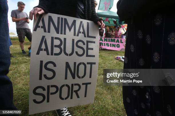 Animal Rising supporters gather opposite the main grandstand with signs and banners criticising horse racing on June 3, 2023 in Epsom, England....