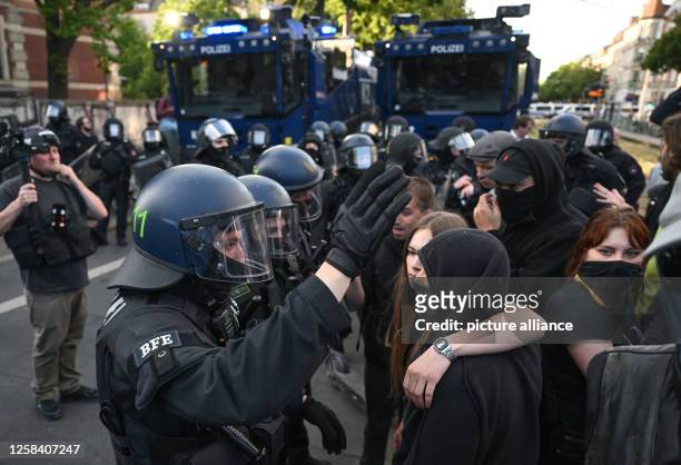 June 2023, Saxony, Leipzig: During protests against the verdict in the trial of Lina E. In Leipzig, police officers push participants of a...