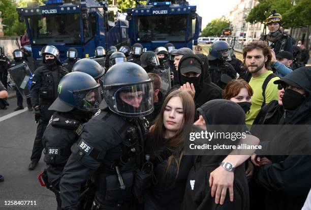 June 2023, Saxony, Leipzig: During protests against the verdict in the trial of Lina E. In Leipzig, police officers push participants of a...