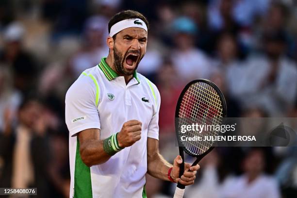 Bulgaria's Grigor Dimitrov celebrates a point against Germany's Daniel Altmaier during their men's singles match on day seven of the Roland-Garros...