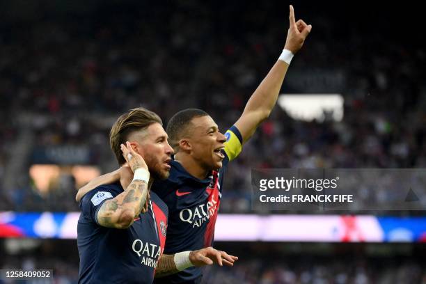 Paris Saint-Germain's Spanish defender Sergio Ramos celebrates scoring his team's first goal with Paris Saint-Germain's French forward Kylian Mbappe...