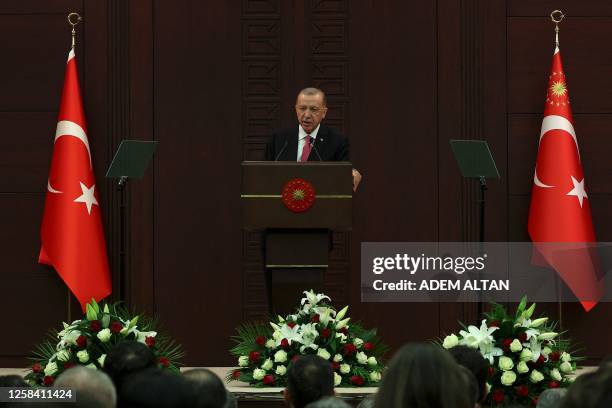 Turkish President Recep Tayyip Erdogan delivers a speech as he unveils the country's new cabinetat Cankaya Palace after he was sworn in as President...