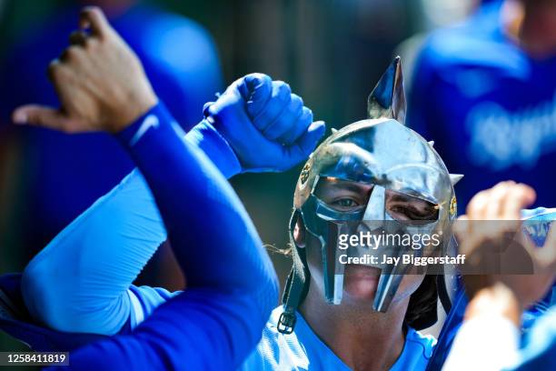 Nick Pratto of the Kansas City Royals puts on a mask to celebrate with teammates in the dugout after hitting a home run during the first inning...