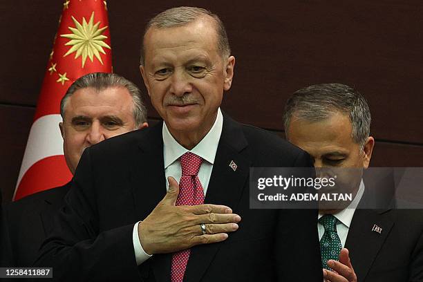 Turkey's President Recep Tayyip Erdogan gestures next to Turkey's new Interior Minister Ali Yerlikaya as he unveils the country's new cabinet at...