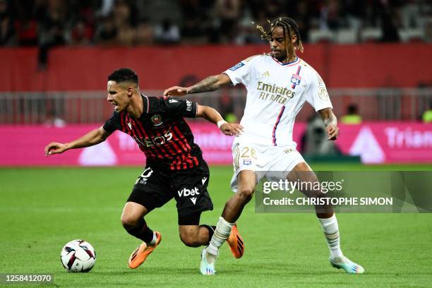 Nice's French midfielder Sofiane Diop fights for the ball with Lyon's French forward Bradley Barcola during the French L1 football match between OGC...