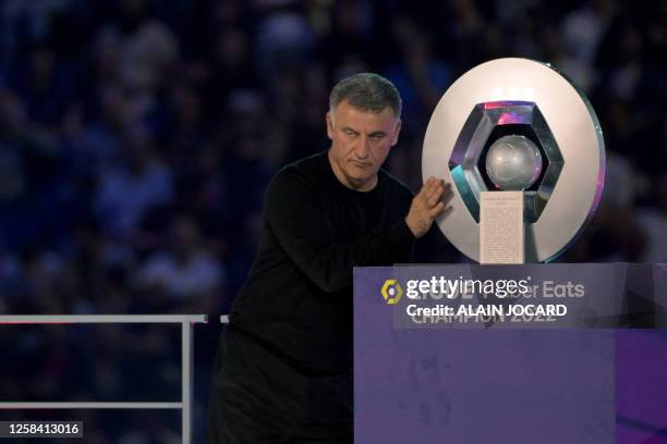 Paris Saint-Germain's French head coach Christophe Galtier poses with the trophy after Paris Saint-Germain's French L1 championship during the...