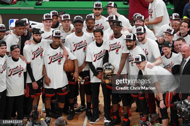 The Miami Heat pose for a photo with the Larry Bird Trophy and the Bob Cousy Trophy after winning Game 7 of the Eastern Conference Finals 2023 NBA...