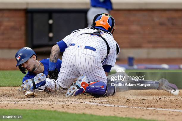Tomas Nido of the New York Mets tags out Cavan Biggio of the Toronto Blue Jays during the eighth inning at Citi Field on June 3, 2023 in the Queens...