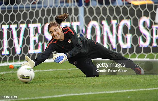 Goal Keeper Hope Solo of the United States dives for a ball during pre-game warm up drills before a game against Canada on September 17, 2011 at...