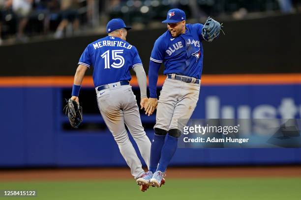George Springer of the Toronto Blue Jays and Whit Merrifield of the Toronto Blue Jays celebrate a 2-1 win against the New York Mets at Citi Field on...