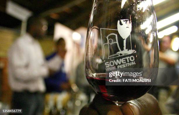 Soweto residents taste wine at the Soweto wine festival in South Africa 01 September 2005. Soweto is the first black township to host an event like...