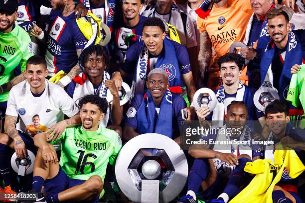 Nuno Mendes of Paris Saint Germain poses for photos with the champions trophy while celebrates with his teammates after winning France Ligue 1 2023...