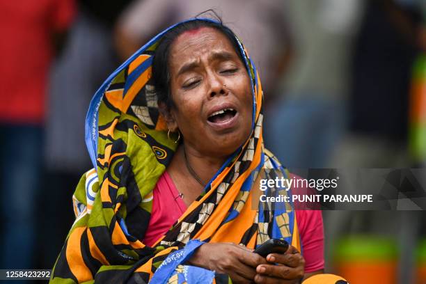 Graphic content / TOPSHOT - A victim's family member weeps at a business park used as temporary mortuary to identify the dead recovered from the...