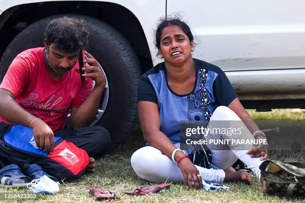 Graphic content / A victim's family member weeps at a business park used as temporary mortuary to identify the dead recovered from the carriage...