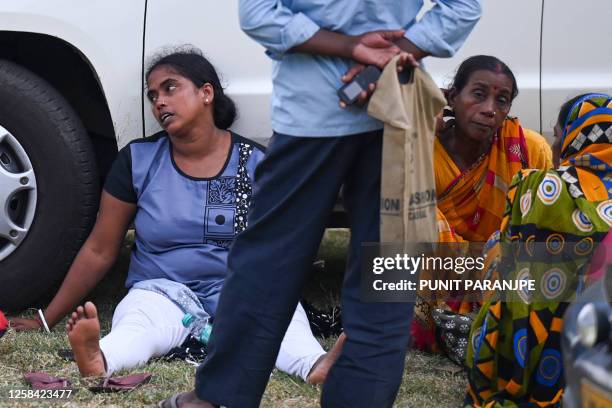 Graphic content / Victims' family members weep at a business park used as temporary mortuary to identify the dead recovered from the carriage...