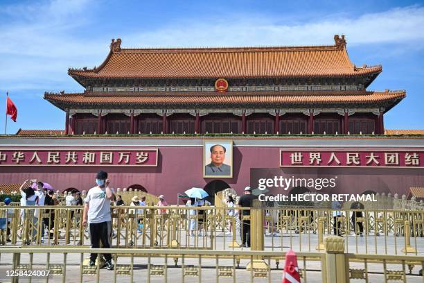 People walk around the Tiananmen Gate in Beijing on June 4 during the 34rd anniversary of the June 4, 1989 crackdown on pro-democracy protests.