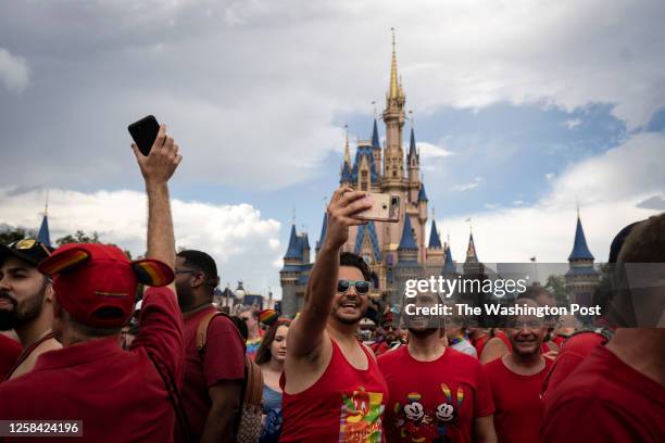 Christopher Casanova, left takes a selfie with Danny Eguizabal after a group photo was taken in front of the Cinderella Castle at Disney World's...