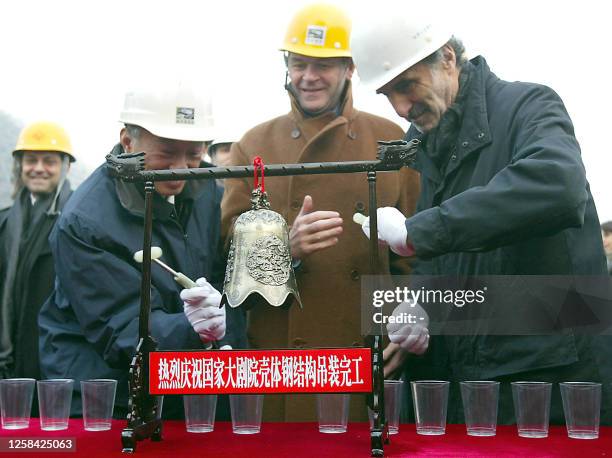 France's Minister for Culture and Communication Jean-Jacques Aillagon witnesses a ceremony for the laying of the last roof beam at the construction...