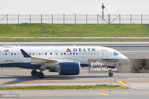 Delta Air Lines Airbus A220 aircraft taxiing at LaGuardia LGA airport in New York City. The modern narrow-body passenger airplane of Delta Airlines...