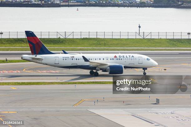 Delta Air Lines Airbus A220 aircraft taxiing at LaGuardia LGA airport in New York City. The modern narrow-body passenger airplane of Delta Airlines...