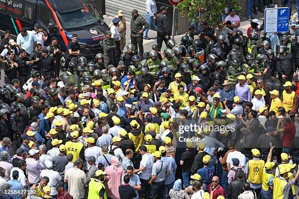 Moroccan Riots Riot police stand guard as members of Morocco's Democratic... News ...
