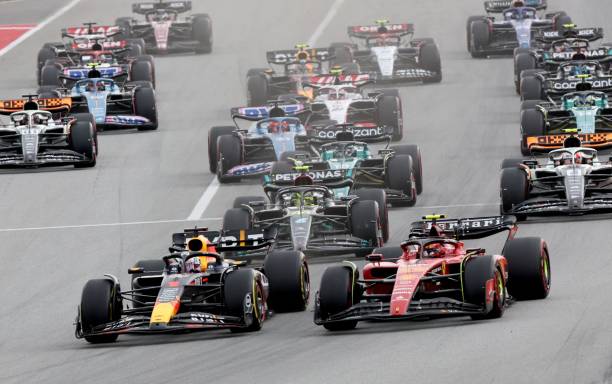 Red Bull's Dutch driver Max Verstappen (L) and Ferrari's Spanish driver Carlos Sainz Jr (R) take the start of the Spanish Formula One Grand Prix race at the Circuit de Catalunya on June 4, 2023 in Montmelo, on the outskirts of Barcelona.