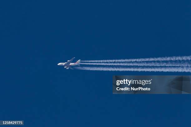 Emirates Airbus A380 double decker passenger aircraft as seen flying in the blue sky over Germany in Europe, the is route EK3 from Dubai DXB, UAE to...