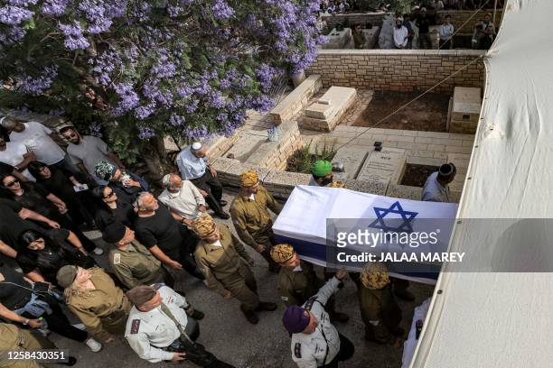 Soldiers carry the coffin of Staff Sergeant Ori Izhak Iluz, one of three Israeli soldiers killed in the cross-border incident with Egypt, during the...