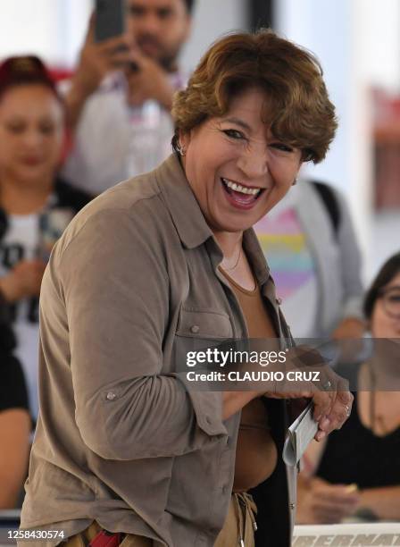 Delfina Gomez, candidate for governor for the State of Mexico for a coalition led by the ruling Morena political party, laughs as she votes at a...