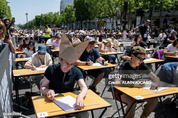 Members of the public take photographs of participants attempting to beat the record of the "World's Biggest Dictation" on the prestigious...