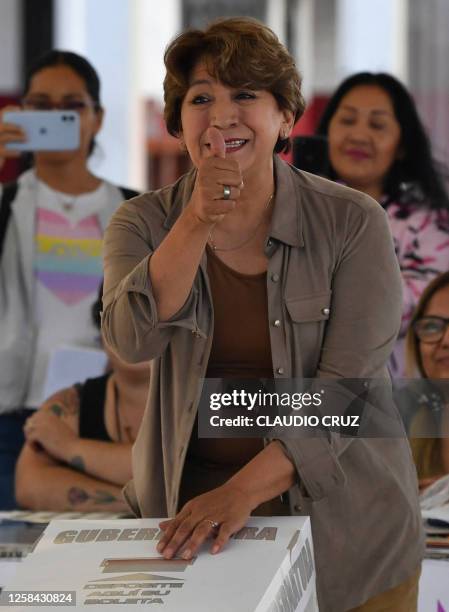 Delfina Gomez, candidate for governor for the State of Mexico for a coalition led by the ruling Morena political party, gives her thumb up as she...