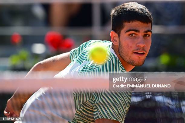 Spain's Carlos Alcaraz Garfia eyes the ball as he plays against Italy's Lorenzo Musetti during their men's singles match on day eight of the...