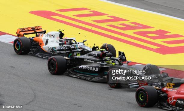 Mercedes' British driver Lewis Hamilton and McLaren's British driver Lando Norris collude during the Spanish Formula One Grand Prix race at the...