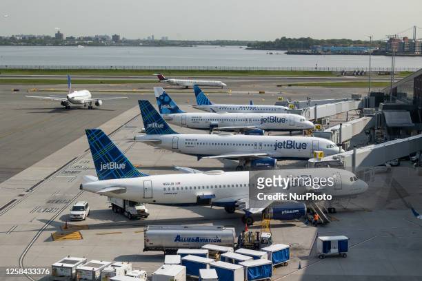 JetBlue Airbus A320 series passenger aircraft of the low cost airline as seen at the tarmac and jet bridges of LaGuardia Airport in New York City...
