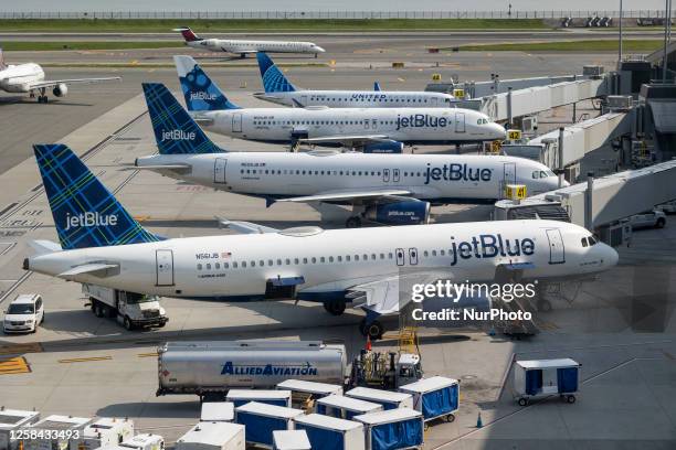 JetBlue Airbus A320 series passenger aircraft of the low cost airline as seen at the tarmac and jet bridges of LaGuardia Airport in New York City...