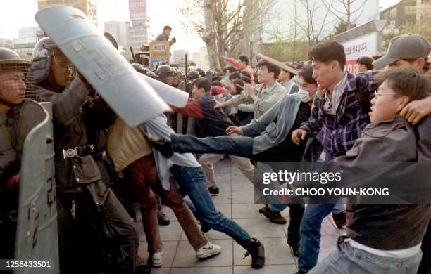 South Korean students clash with riot police during an anti-US demonstration 16 April 1994. Some 1,000 people were protesting the deployment of...
