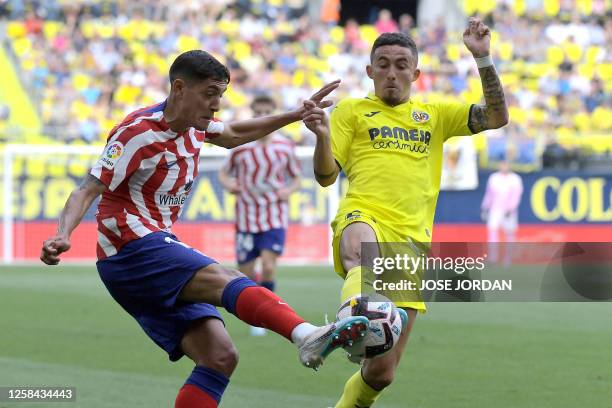 Atletico Madrid's Argentine defender Nahuel Molina vies with Villarreal's Spanish midfielder Yeremi Pino during the Spanish league football match...