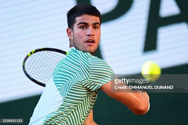 Spain's Carlos Alcaraz Garfia eyes the ball as he plays against Italy's Lorenzo Musetti during their men's singles match on day eight of the...