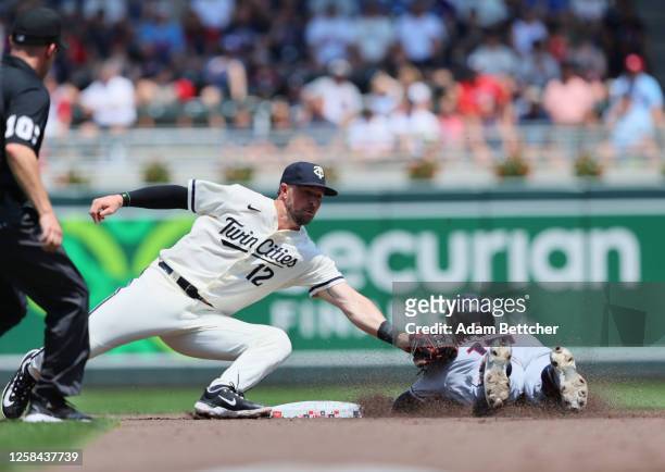 Kyle Farmer of the Minnesota Twins makes the double play on Will Brennan of the Cleveland Guardians in the third inning at Target Field on June 4,...