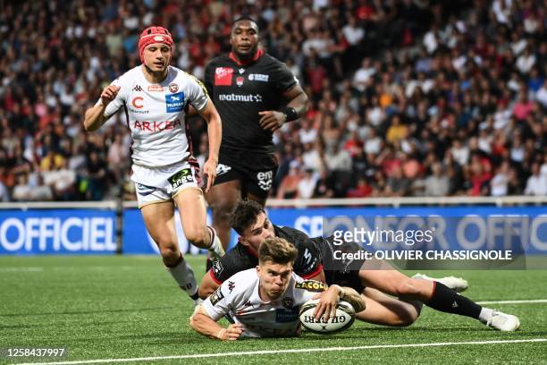 Bordeaux-Begles' French fly-half Matthieu Jalibert scores a try during the French Top14 rugby union qualifying match between Lyon Olympique...
