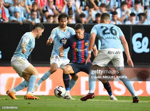 Barcelona's Polish forward Robert Lewandowski vies with Celta Vigo's Spanish defender Javi Galan , Celta Vigo's US midfielder Luca de la Torre and...