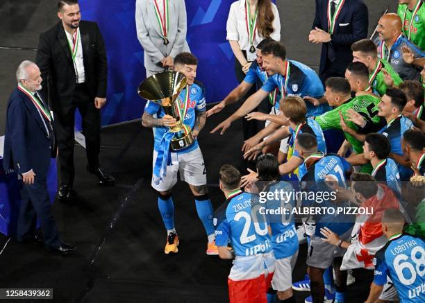 Napoli's Italian defender Giovanni Di Lorenzo holds the Italian Scudetto Championship trophy as he, owner of SSC Napoli football club, Aurelio De...