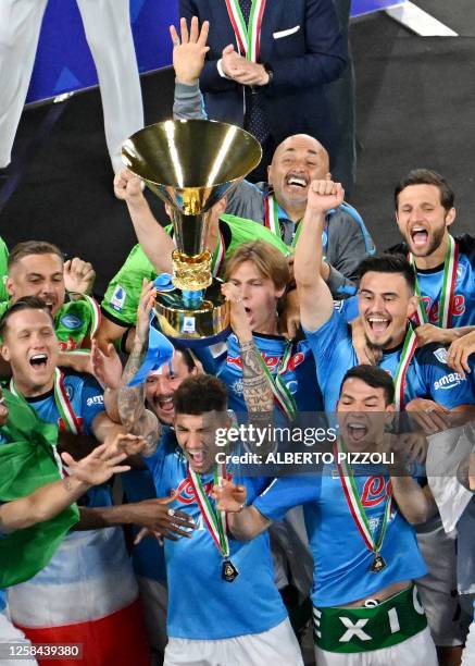 Napoli's Italian defender Giovanni Di Lorenzo , holding the Italian Scudetto Championship trophy, Napoli's Italian coach Luciano Spalletti and...