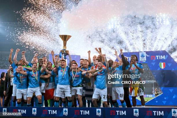 Napoli's Italian defender Giovanni Di Lorenzo holds the Italian Scudetto Championship trophy as he and his teammates celebrate winning the 2023...