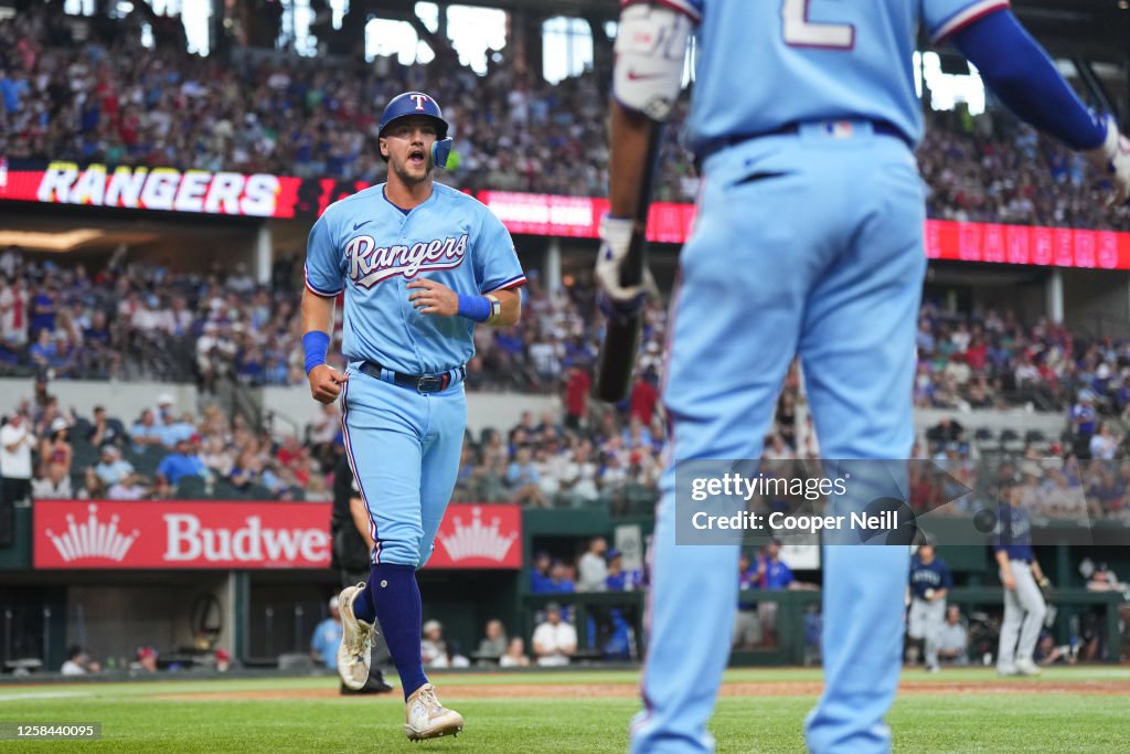 Seattle Rangers Josh Jung of the Texas Rangers returns to the dugout after scoring ...