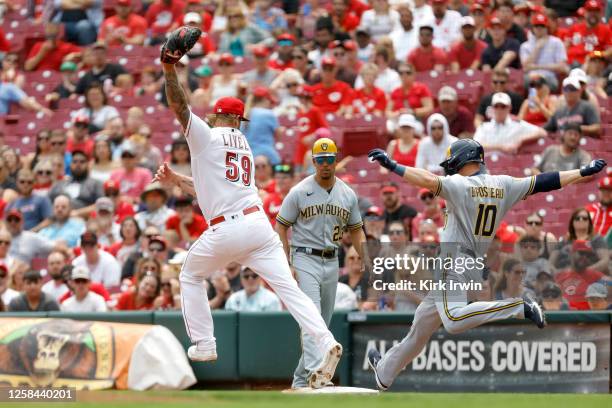 Ben Lively of the Cincinnati Reds forces out Mike Brosseau of the Milwaukee Brewers at first base during the fourth inning of the game at Great...