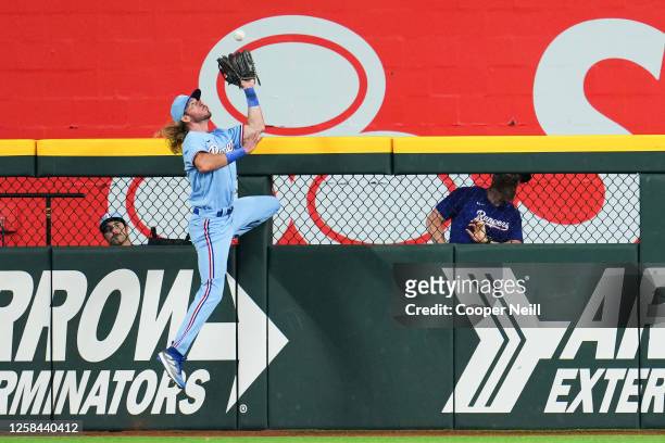 Travis Jankowski of the Texas Rangers makes a leaping catch at the outfield fence off a hit from Mike Ford of the Seattle Mariners in the fifth...