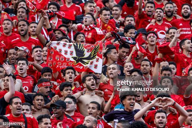 Fans of Egypt's Al-Ahly cheer for their team ahead of the first-leg final football match of the CAF Champions League, between Ahly and Morocco's...