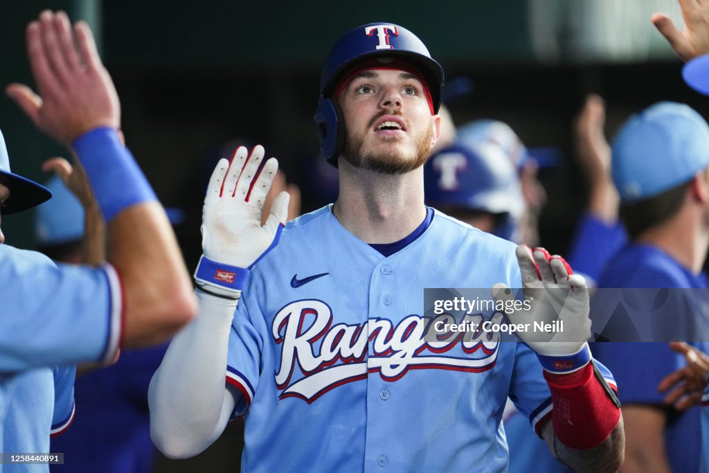 Texas Ranger Heim Jonah Heim of the Texas Rangers high-fives teammates in the dugout ...